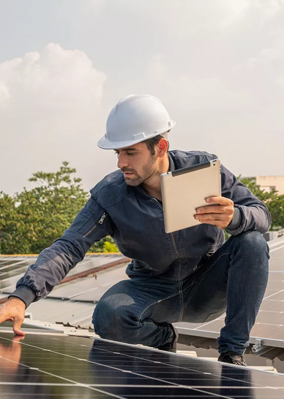 Technician checking commercial roof with solar panel installation